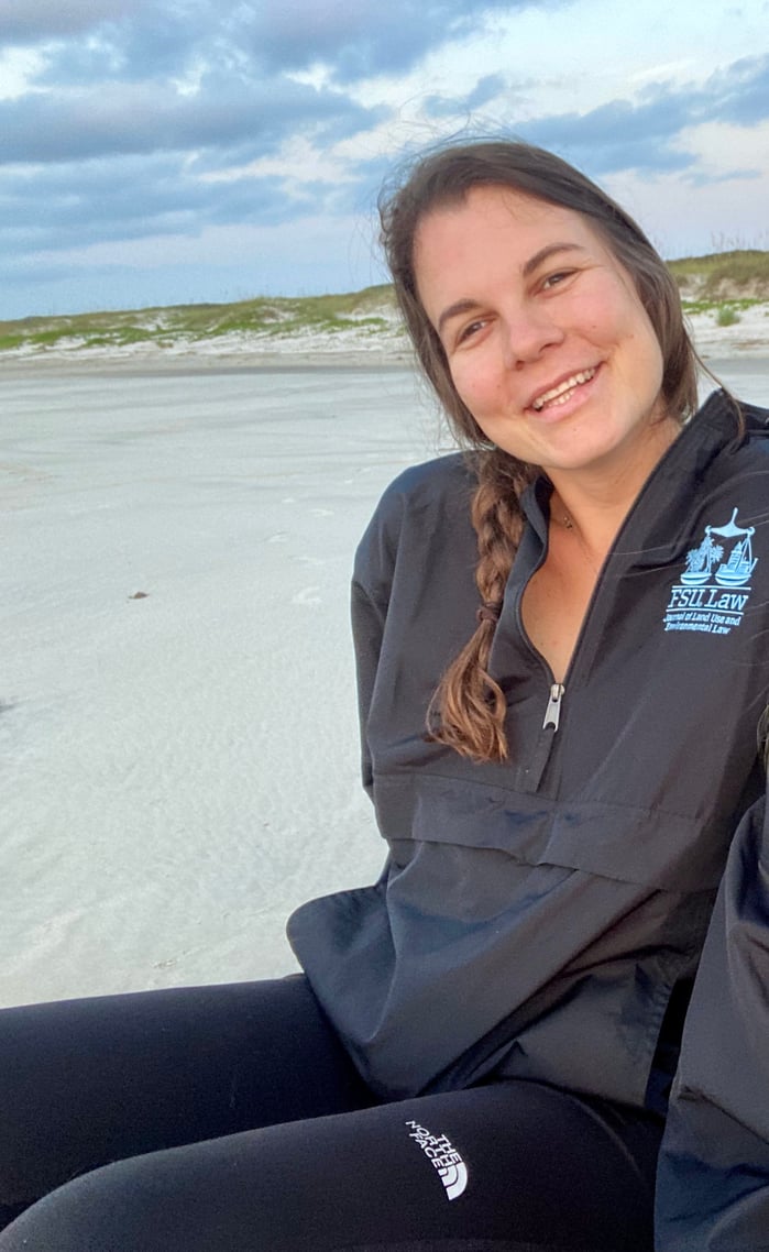 Katie sitting on beach